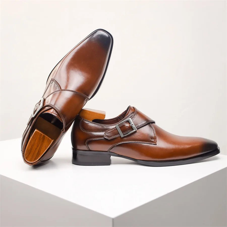 Brown leather monk strap shoe shown side-on with sole and buckle visible