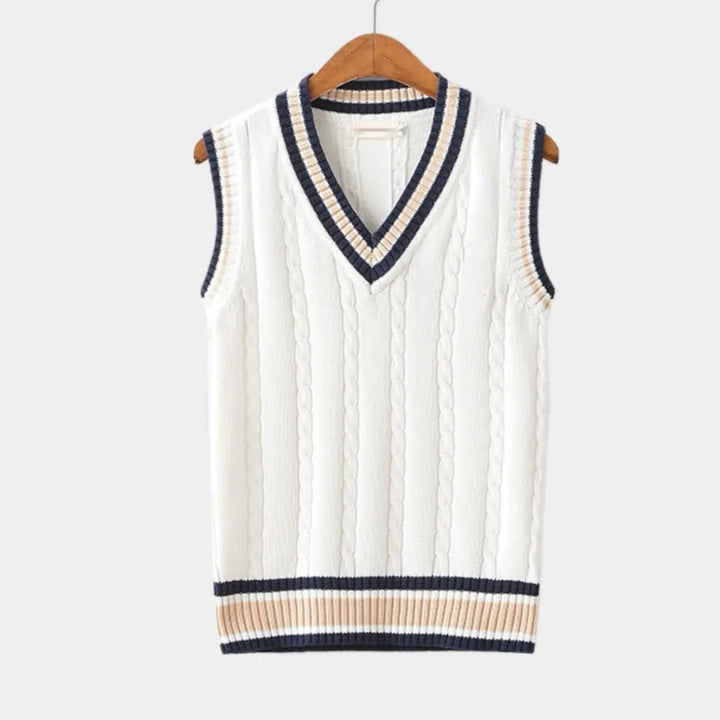 White cable-knit sweater vest with navy and beige striped V-neck trim