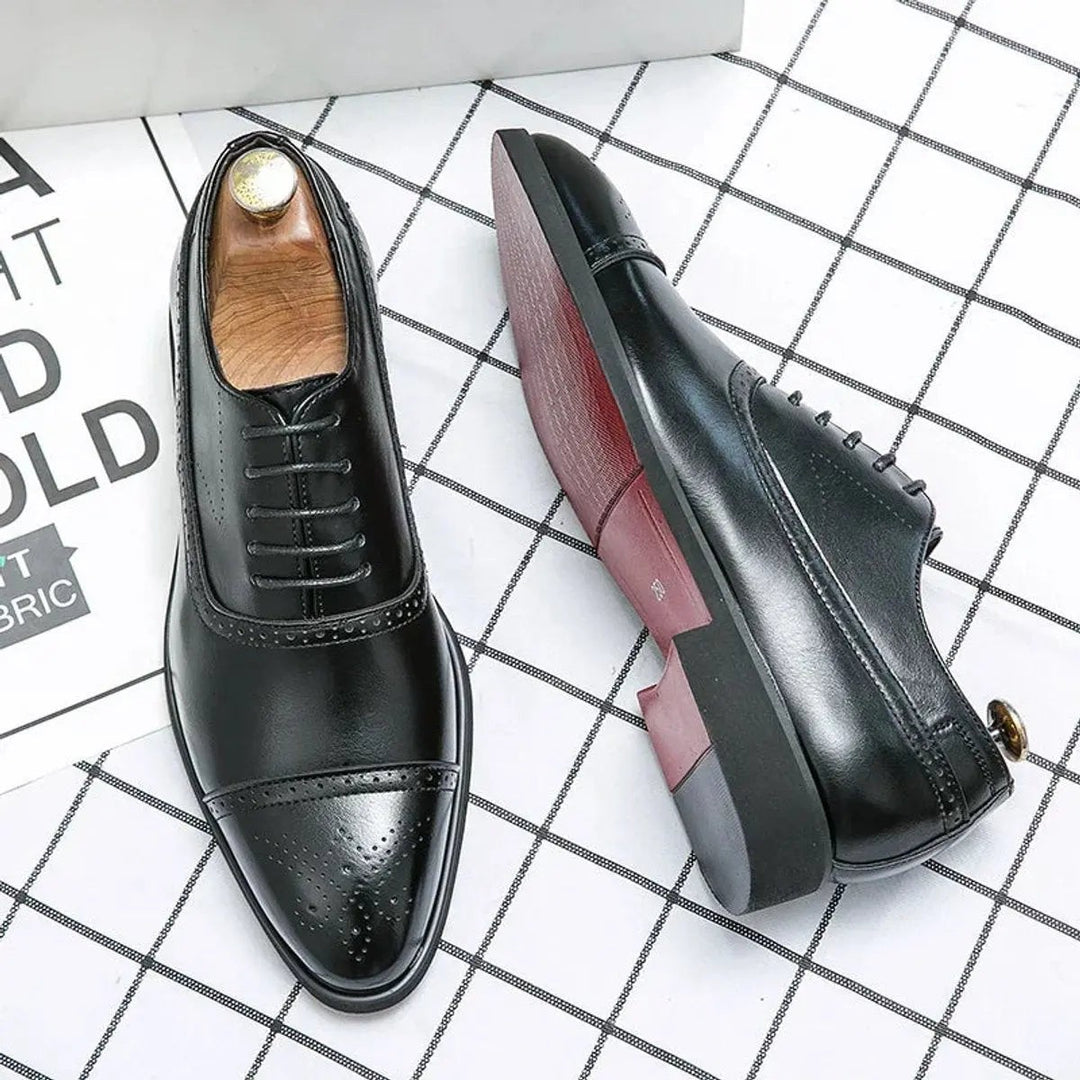 Black leather cap-toe brogue Oxford shoes with red sole detailing