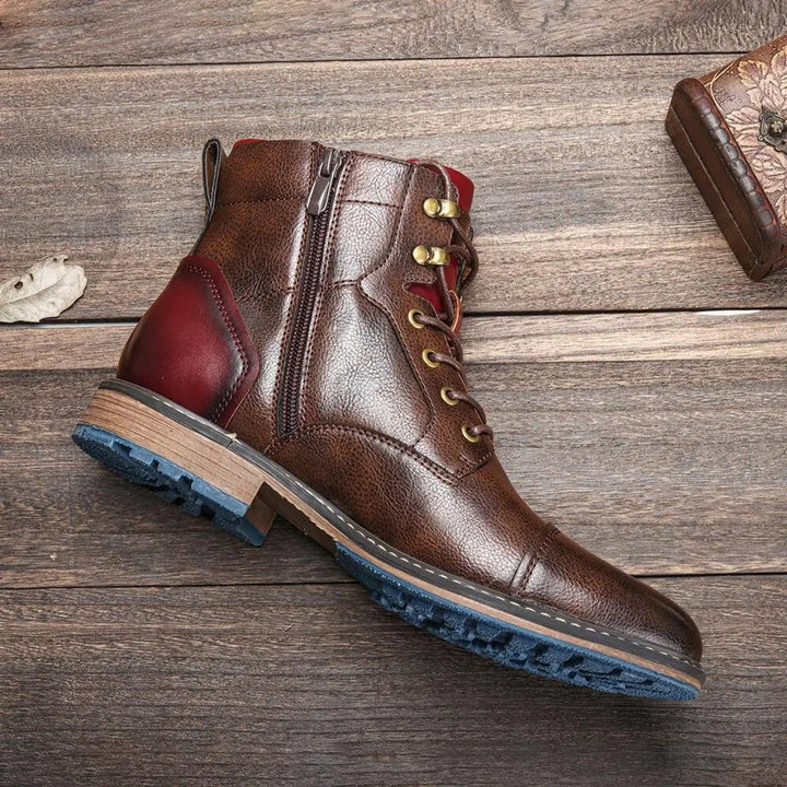 Side view of brown leather ankle boot with red suede heel accent