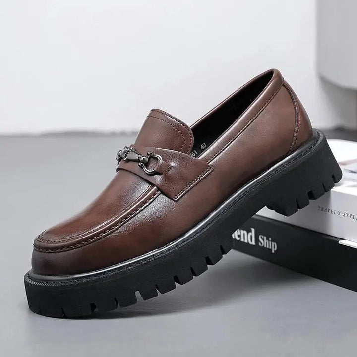 Brown leather loafer with metal buckle trim and chunky black cleated sole