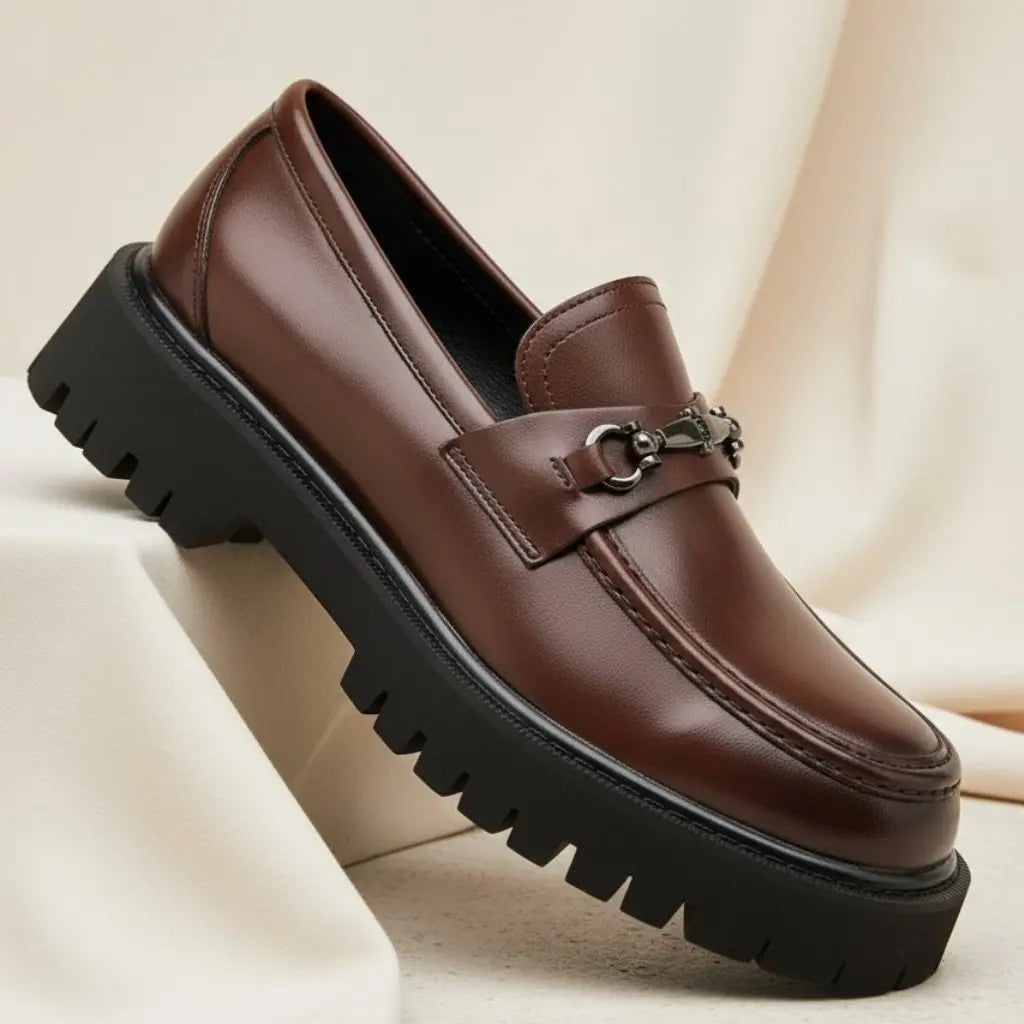 Dark brown leather loafer featuring horsebit buckle and rugged platform sole