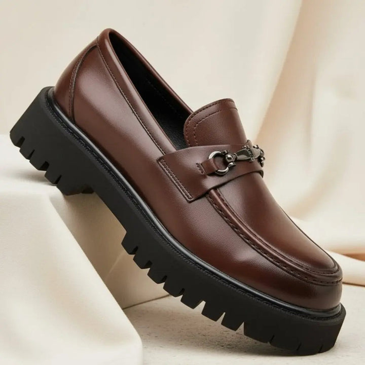 Dark brown leather loafer featuring horsebit buckle and rugged platform sole