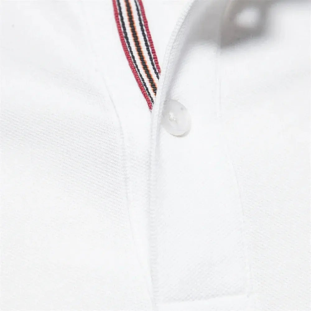 Detail view of white polo shirt collar with red and navy striped placket trim