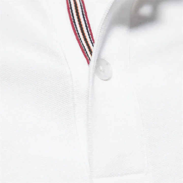 Detail view of white polo shirt collar with red and navy striped placket trim