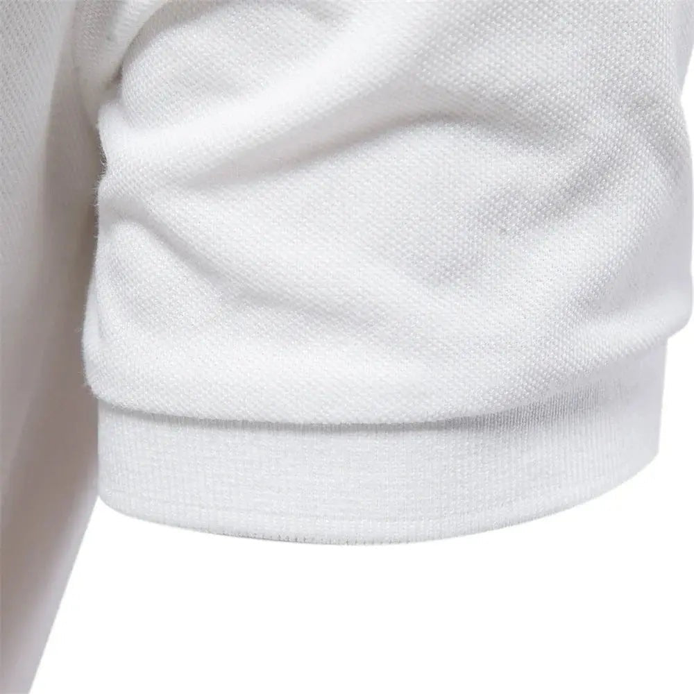 Close-up of ribbed cuff detail on a white cotton polo shirt sleeve