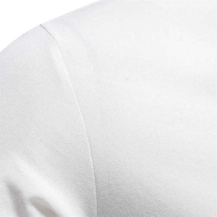 Close-up of white polo shirt sleeve seam showing textured pique cotton fabric