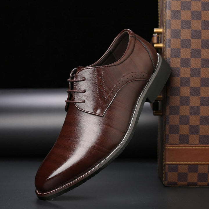 Brown leather lace-up formal shoe with pointed toe and brogue detailing