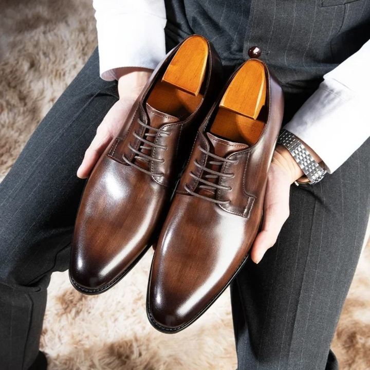 Brown leather derby dress shoes with polished burnished toe and shoe trees inserted