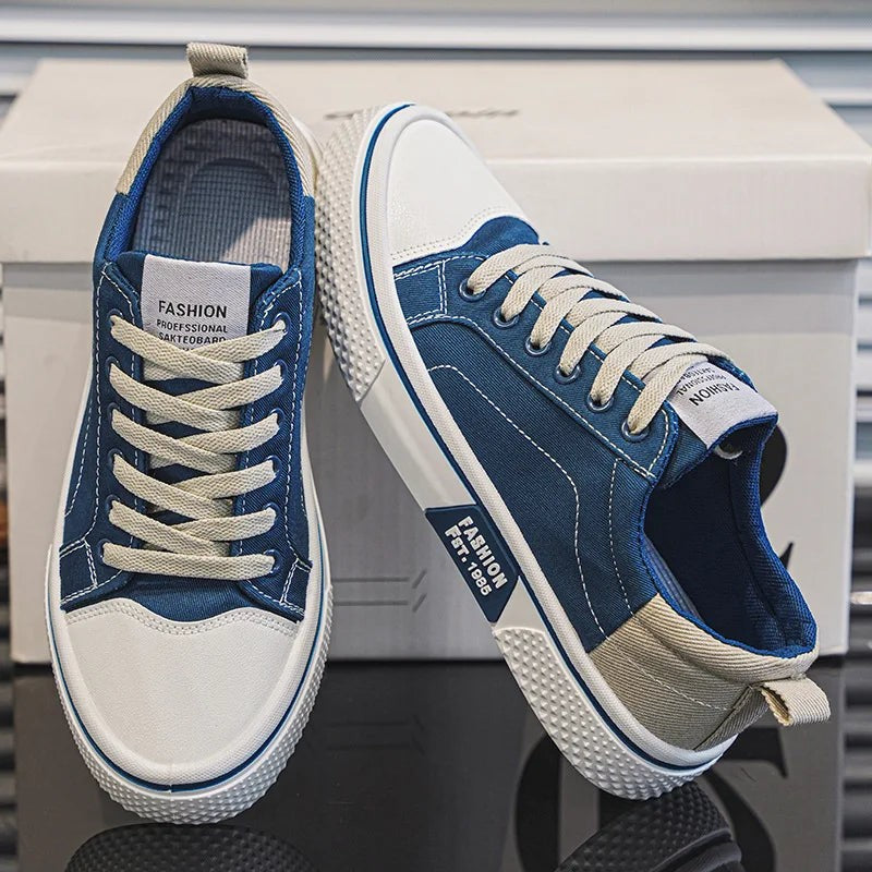 Navy blue canvas lace-up trainers with white rubber toe caps and contrast heel tabs
