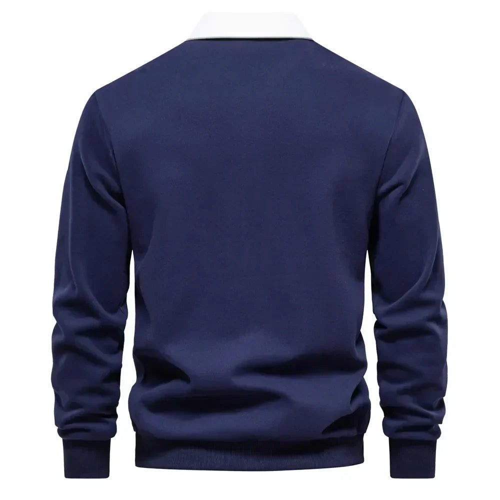 Rear view of navy long-sleeve golf polo jumper showing ribbed cuffs and hem