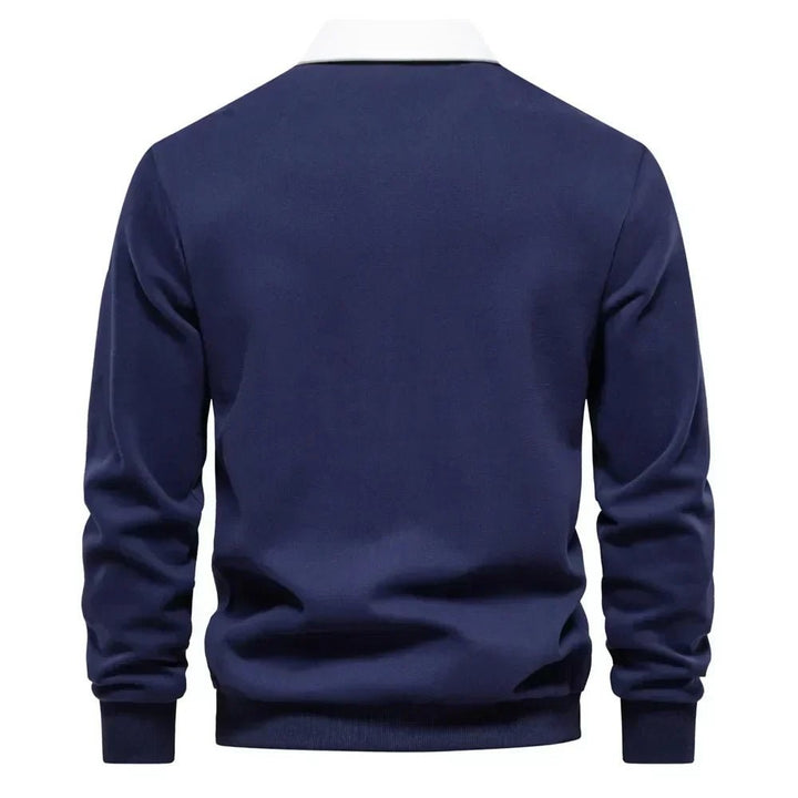 Rear view of navy long-sleeve golf polo jumper showing ribbed cuffs and hem
