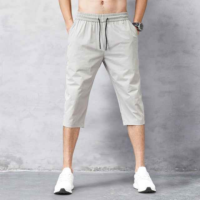 Light grey cropped jogger trousers with drawstring waist and side pockets