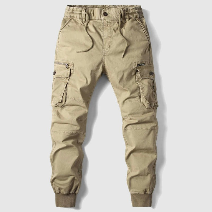 Khaki cargo joggers with elasticated waist and multiple zip pockets, flat lay