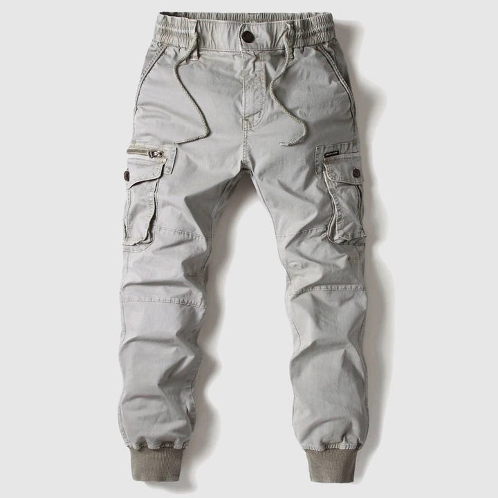 Light grey cargo joggers featuring ribbed cuffs and multiple pockets, flat lay