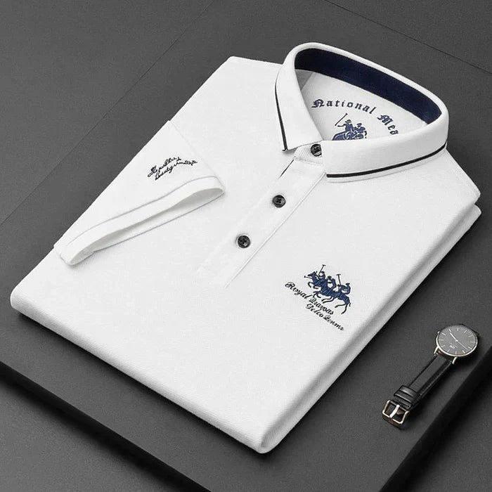 White men's polo shirt folded with navy-striped collar and embroidered crest detail