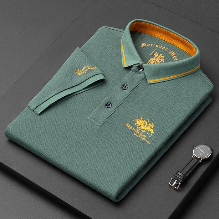 Sage green men's polo shirt folded with mustard-striped collar and embroidered logo