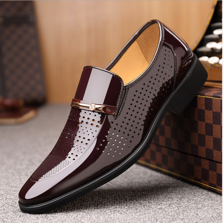 Burgundy patent leather loafer with perforated side detailing beside box