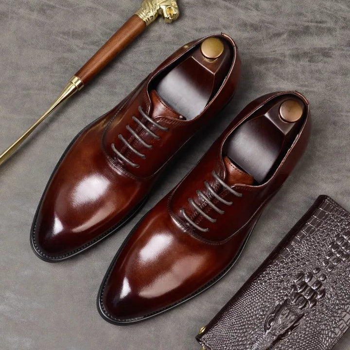 Burgundy leather lace-up shoes with pointed toe and glossy finish, top view