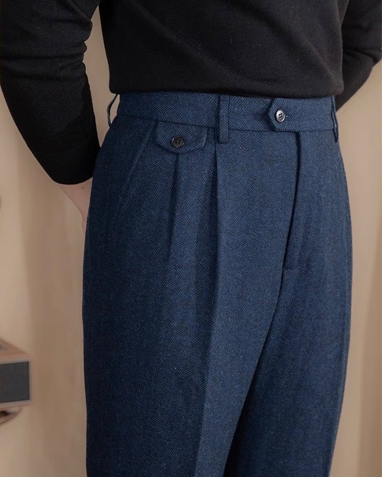 Navy herringbone tweed trousers with tailored waistband and buttoned side adjuster