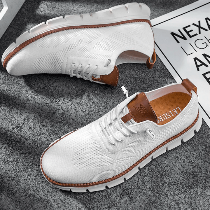White knitted trainers featuring tan leather trim and ridged rubber sole