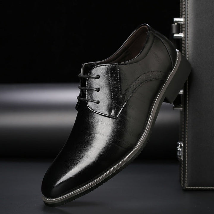 Black leather Derby dress shoe with brogue detailing and pointed toe