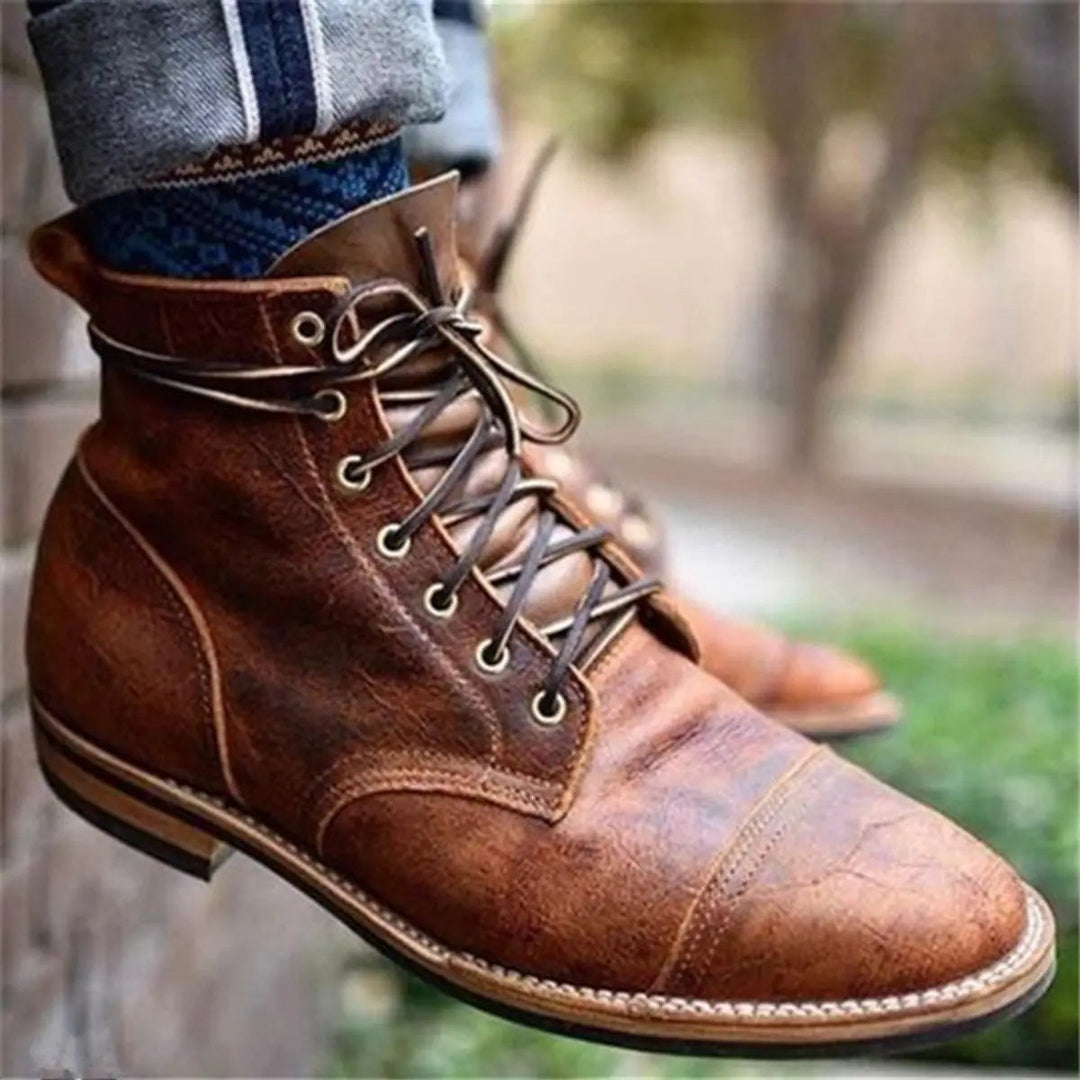 Worn tan leather lace-up ankle boot with stitched cap-toe design