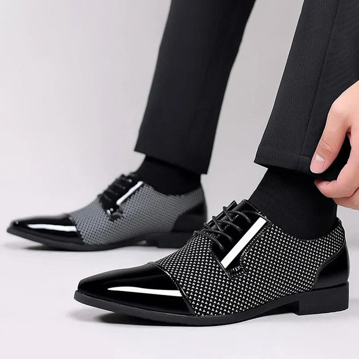 Grey and black patterned Oxford shoes styled on foot with black socks