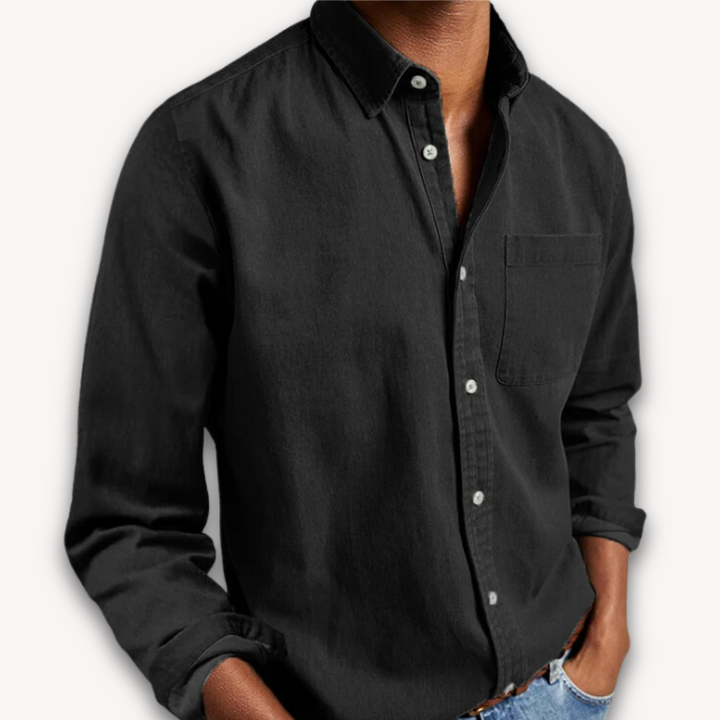Black long-sleeve button-down shirt with chest pocket, worn open-collar casual style