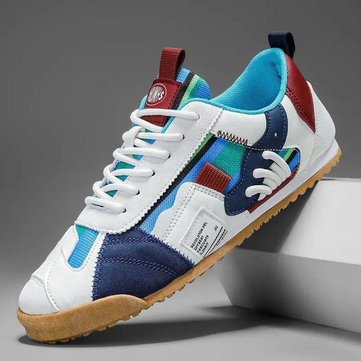 White leather trainer with navy and burgundy panels and gum sole