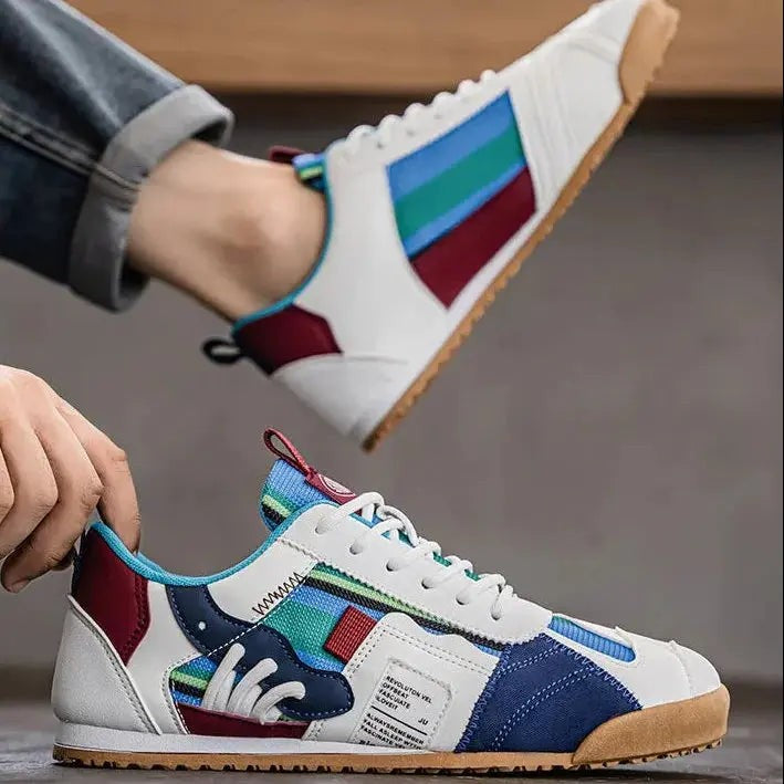 Close-up of striped panel trainer with burgundy heel tab and gum outsole