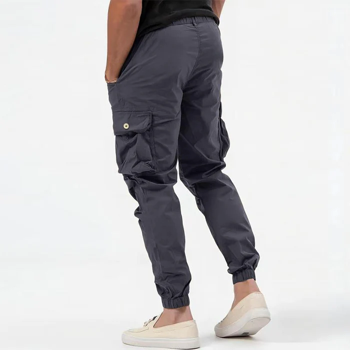 Rear view of grey tactical cargo joggers showing buttoned pocket detail