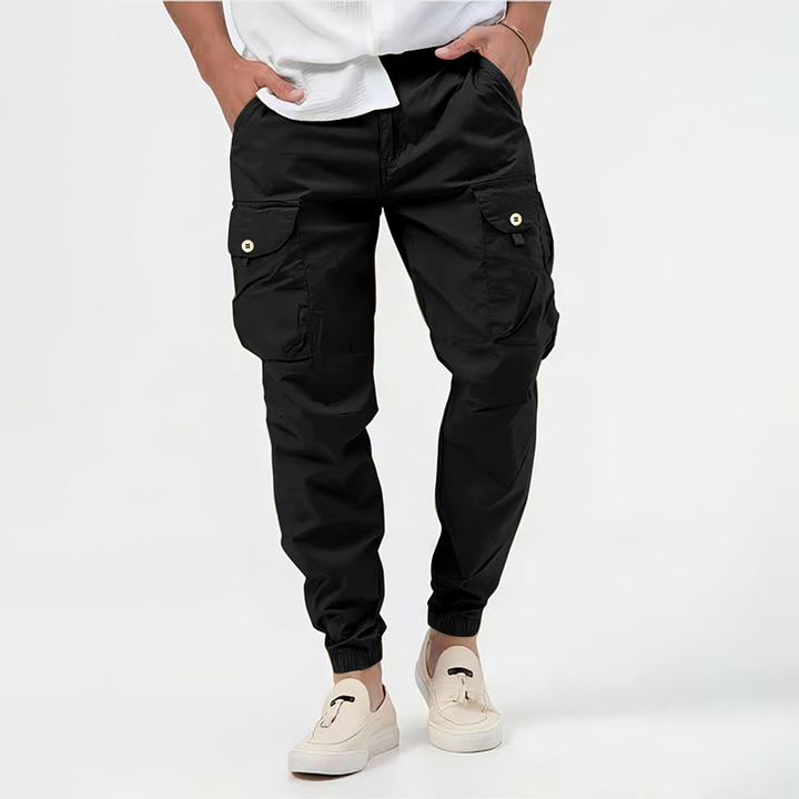 Black tactical cargo joggers featuring buttoned side pockets and slim tapered fit