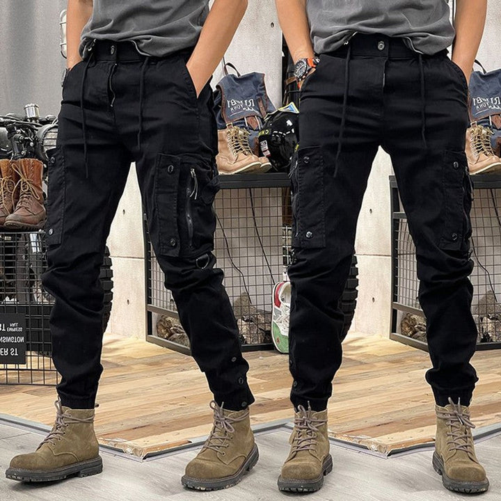 Black cargo trousers with side pockets, drawstring waist and tapered fit