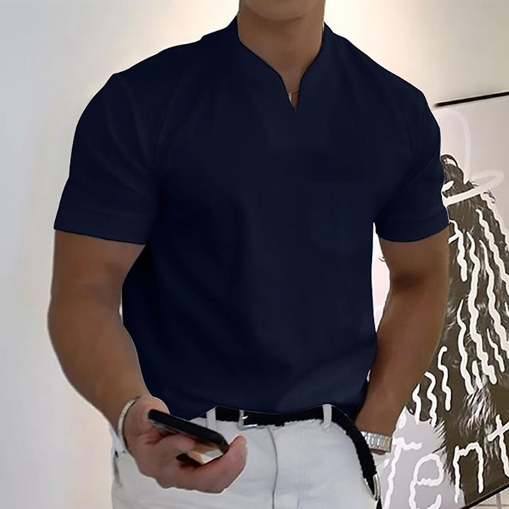 Navy short-sleeve polo shirt featuring notch neckline and front pocket