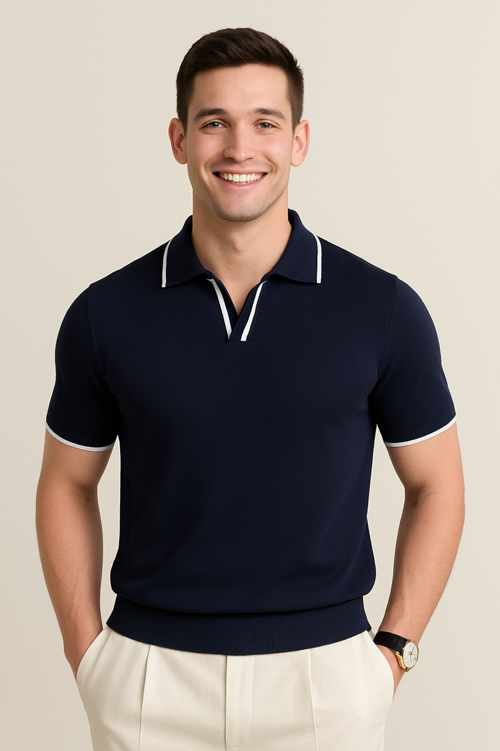 Man wearing navy knit polo shirt with white tipped collar and short sleeves