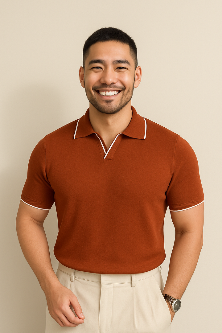 Man wearing rust orange knit polo shirt with white tipped collar trim