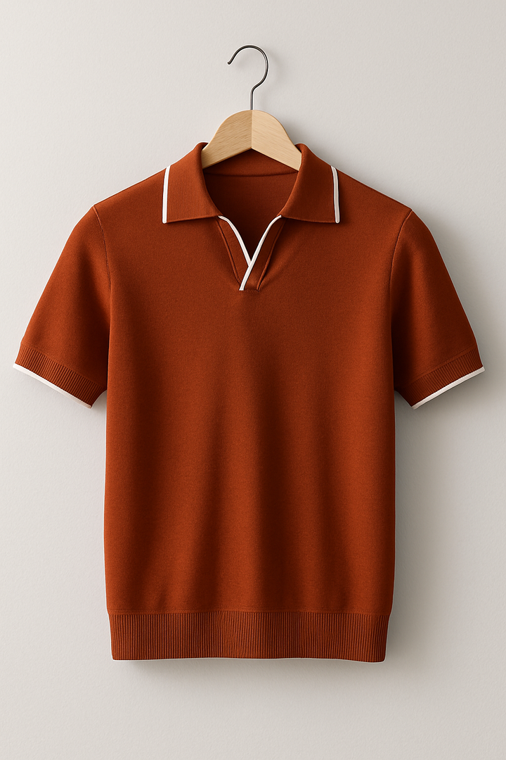Rust orange short sleeve knit polo with white contrast tipping on hanger