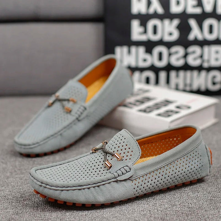 Grey suede perforated loafers shown as a pair with tan lining
