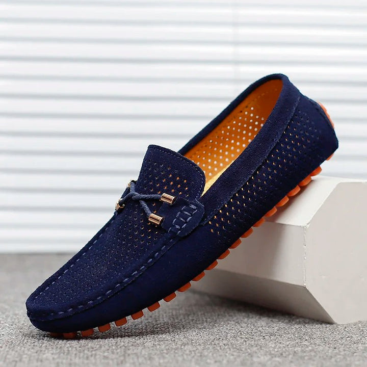 Navy suede perforated loafers with bow lace and orange pebbled sole