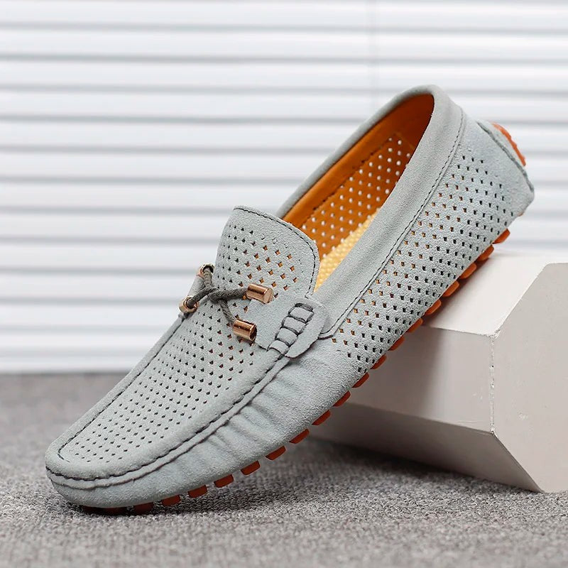 Grey suede perforated driving loafers with tan interior and orange sole