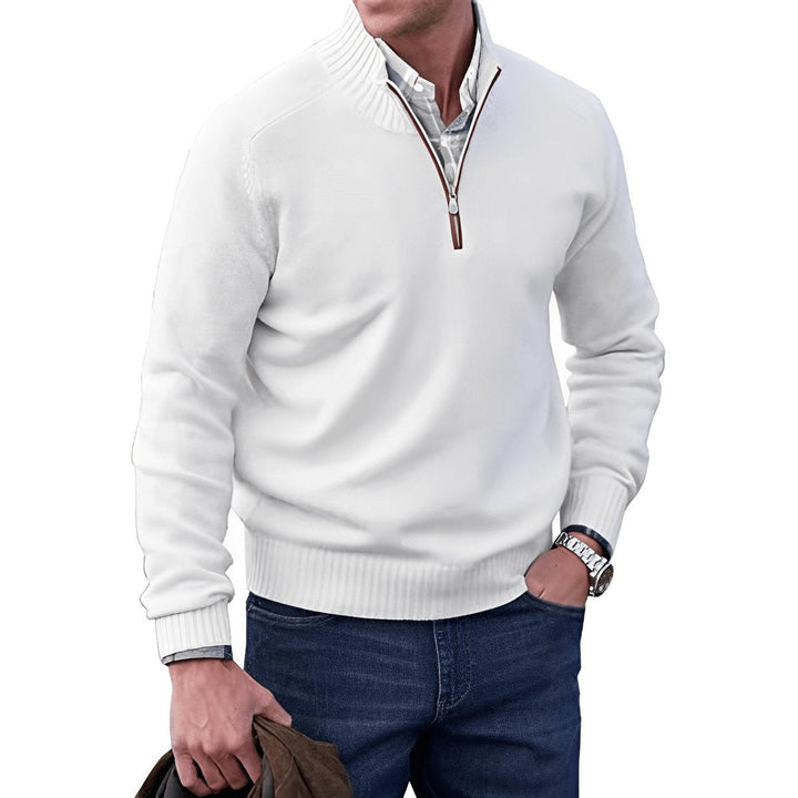 White quarter-zip jumper worn over checked shirt with jeans