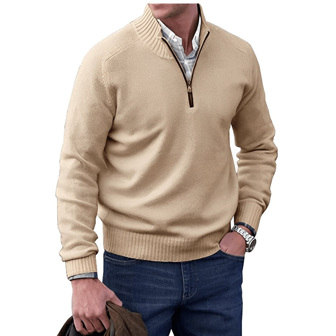 Beige quarter-zip knit jumper styled with denim jeans