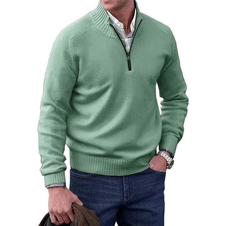 Sage green quarter-zip jumper paired with a checked shirt