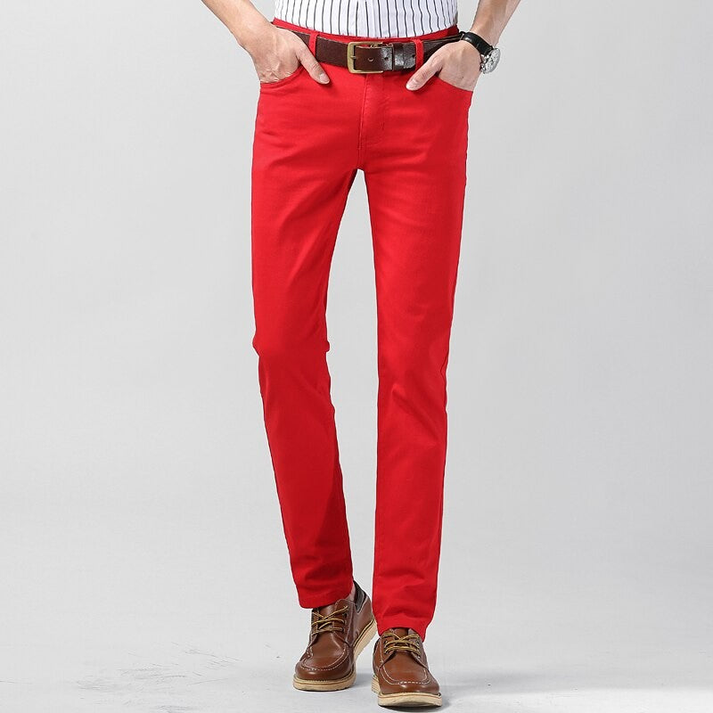 Man wearing red slim-fit straight leg trousers with brown leather belt
