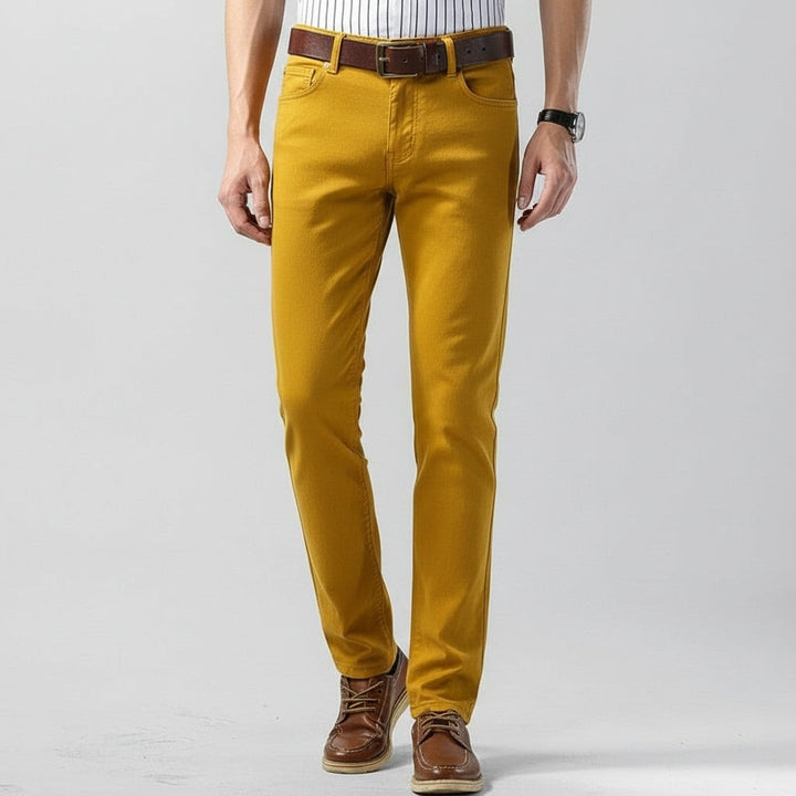 Mustard yellow straight leg trousers styled with a brown leather belt