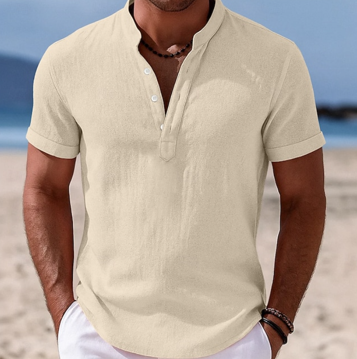 Beige button-up shirt with grandad collar, styled with white shorts on beach