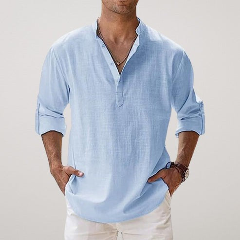 Light blue linen grandad-collar shirt styled with rolled sleeves and white trousers