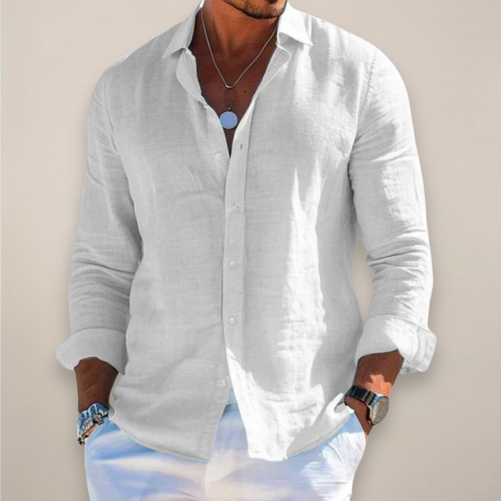 White linen long-sleeve shirt worn open-collared with rolled cuffs