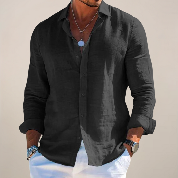 Black linen long-sleeve shirt featuring relaxed fit and rolled sleeves